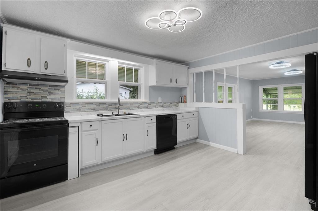 154 County Line Road Southwest Plainville, GA 30733 - Photo 12 of 27 a kitchen with a stove oven and a sink