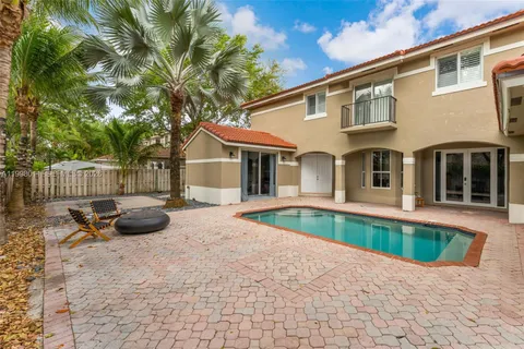 a front view of a house with swimming pool and sitting area