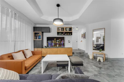 a living room with furniture a rug and a chandelier