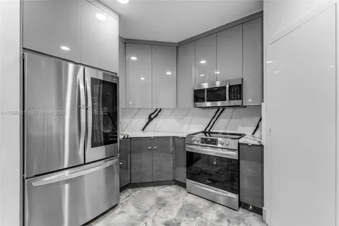 a kitchen with a stove and a refrigerator