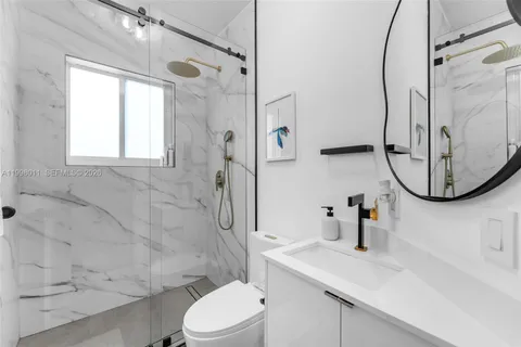 a bathroom with a sink a toilet and a mirror