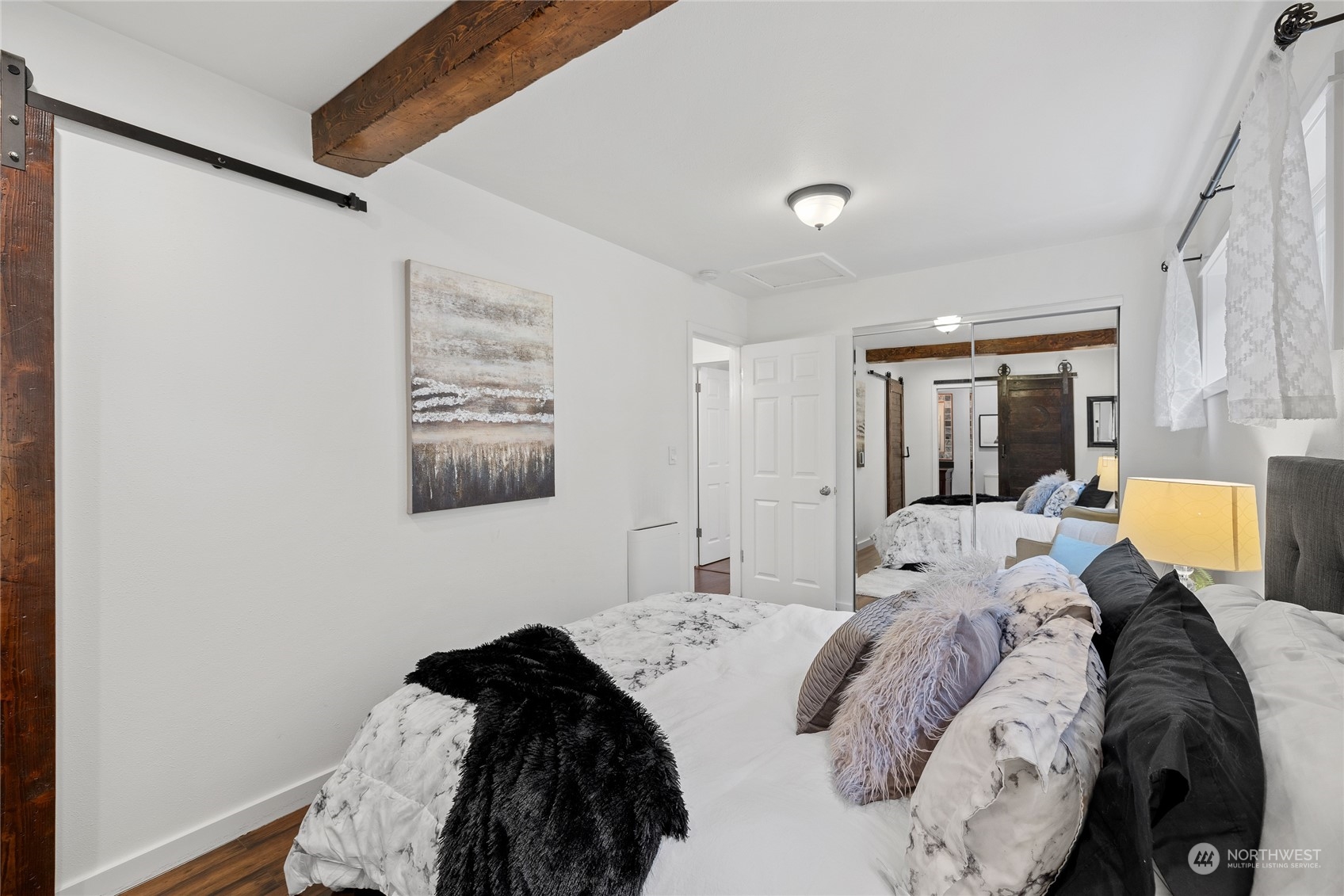 9734 31st Avenue Southwest Seattle, WA 98126 - Photo 16 of 29 a bedroom with a bed and a painting on the wall