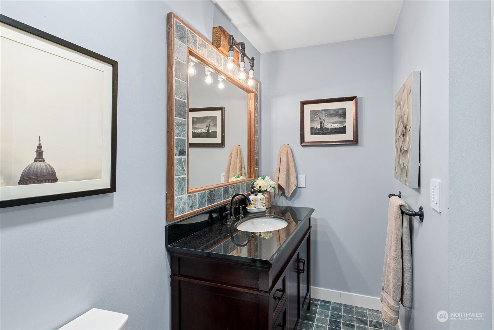 9734 31st Avenue Southwest Seattle, WA 98126 - Photo 18 of 29 a bathroom with a sink and a mirror