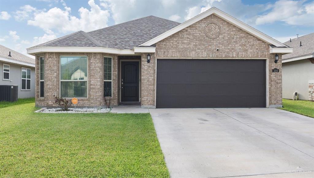 304 South Tecate Drive Mission, TX 78572 - Photo 1 of 1 View of front facade with a garage, a front lawn, and central AC