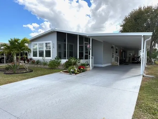 a view of a house with porch and garden