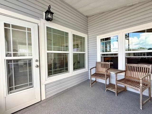 a balcony with furniture and a window