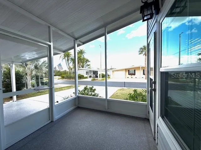 a view of an empty room with large windows