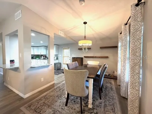 a view of a dining room with furniture window and wooden floor