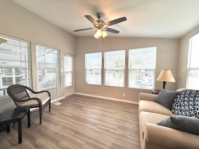 a living room with furniture and two large window