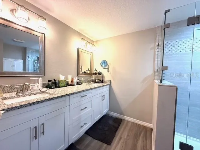 a bathroom with a double vanity sink and a mirror
