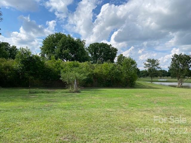 1724 Ruben Road, Unit 5 Monroe, NC 28112 - Photo 4 of 13 a swimming pool with trees in the background