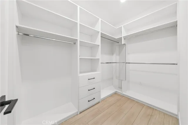 a spacious bathroom with a double vanity sink a mirror and a shower