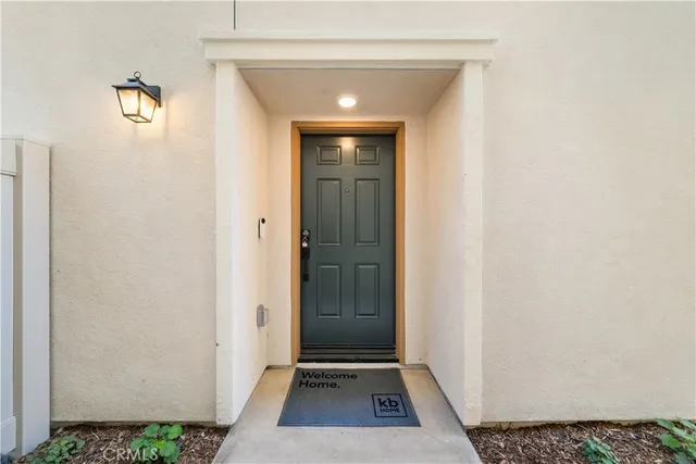 a view of hallway with walk in closet and wooden floor