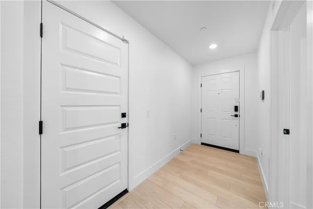 a view of a hallway with stairs and a bathroom
