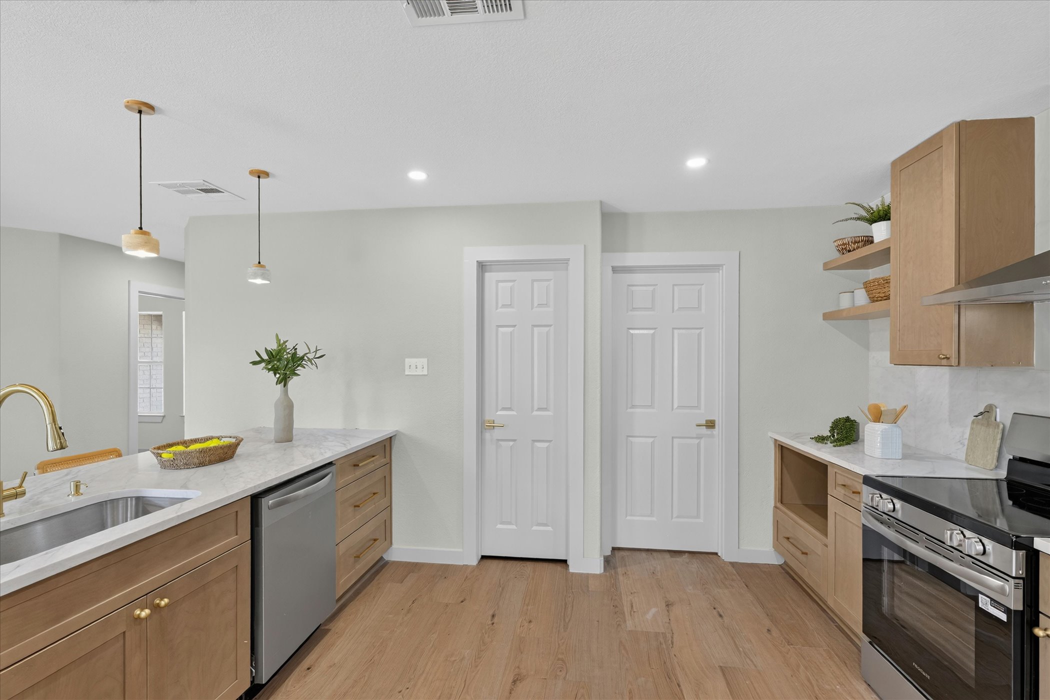 258 Pine View Loop Bastrop, TX 78602 - Photo 22 of 40 Culinary delights await in this bright kitchen with warm wood flooring and sleek countertops.