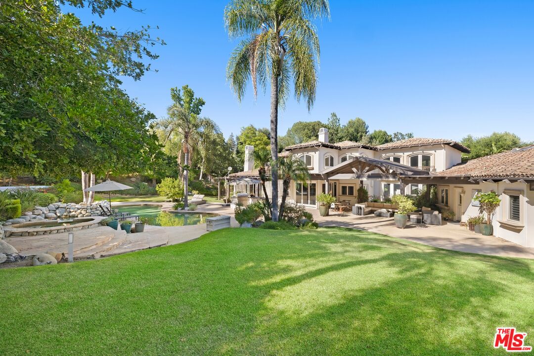 25217 Eldorado Meadow Road Hidden Hills, CA 91302 - Photo 15 of 26 a row of palm trees and a garden