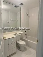 a bathroom with a granite countertop sink a toilet and shower