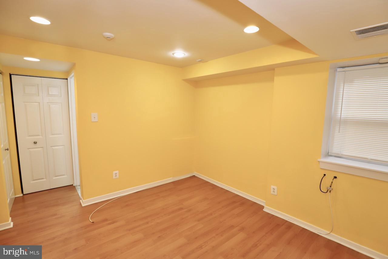 1737 Wallace Street, Unit 101 Philadelphia, PA 19130 - Photo 12 of 15 wooden floor in an empty room with a window