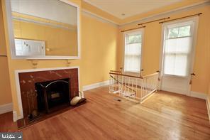 1737 Wallace Street, Unit 101 Philadelphia, PA 19130 - Photo 2 of 15 a living room with furniture and a fireplace