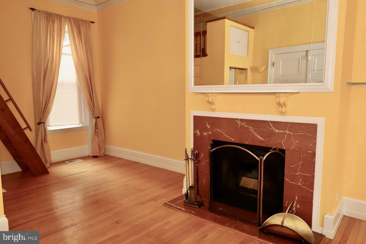 1737 Wallace Street, Unit 101 Philadelphia, PA 19130 - Photo 3 of 15 a living room with furniture and a fireplace