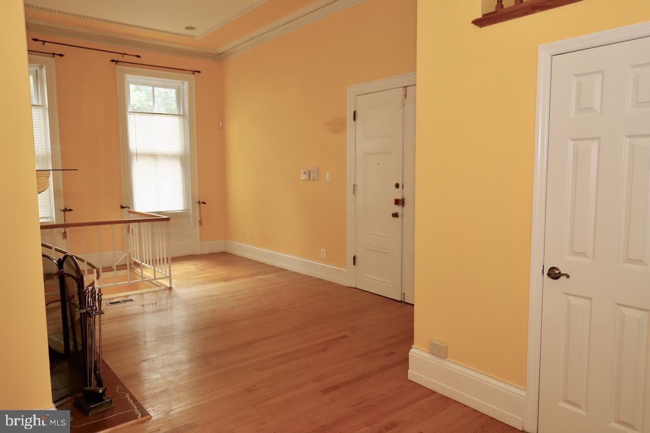 1737 Wallace Street, Unit 101 Philadelphia, PA 19130 - Photo 5 of 15 a view of empty room with wooden floor and fan