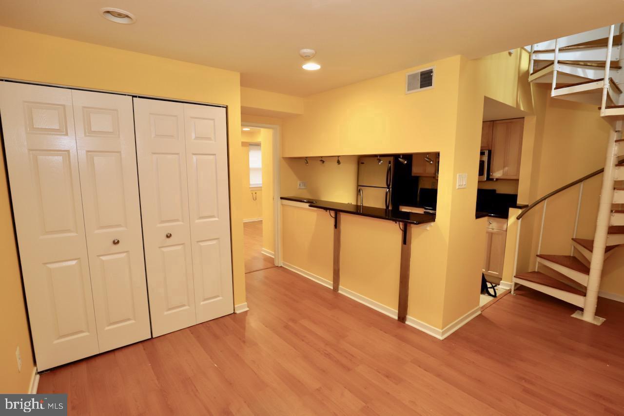 1737 Wallace Street, Unit 101 Philadelphia, PA 19130 - Photo 8 of 15 a view of a livingroom with wooden floor and stairs
