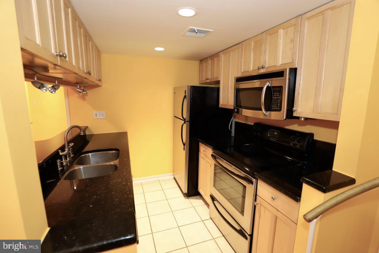 1737 Wallace Street, Unit 101 Philadelphia, PA 19130 - Photo 9 of 15 a kitchen with a sink and cabinets