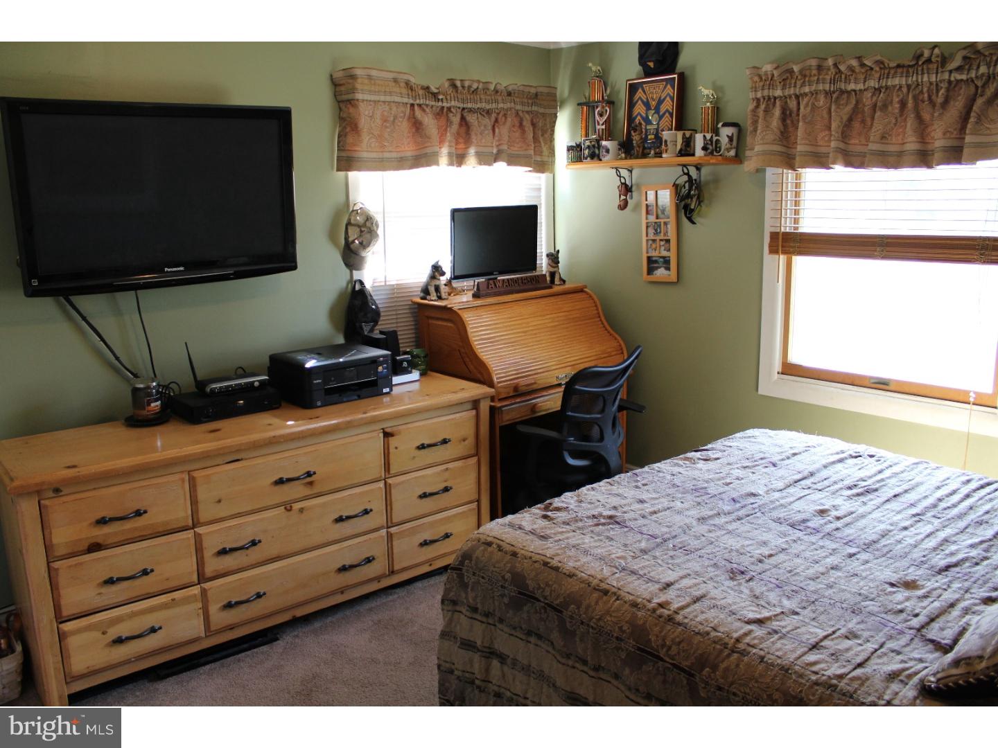 7 Calicobush Road Levittown, PA 19057 - Photo 14 of 25 a bedroom with a bed and flat tv screen on the dresser
