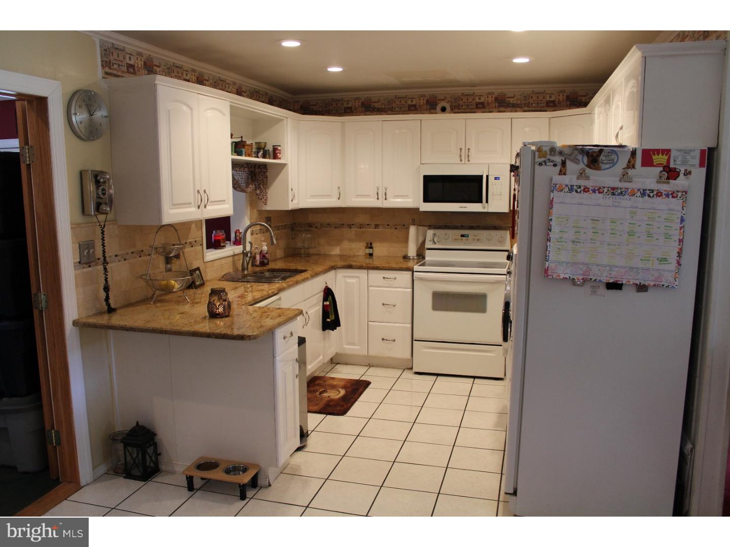 7 Calicobush Road Levittown, PA 19057 - Photo 3 of 25 a kitchen with stainless steel appliances a stove a sink and a refrigerator