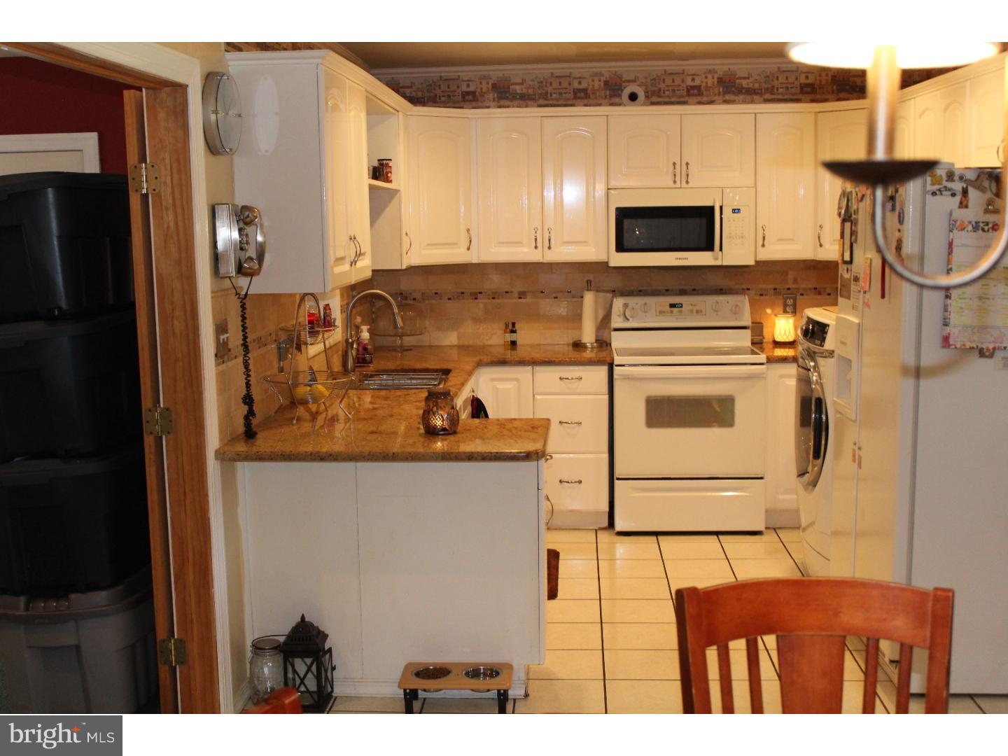 7 Calicobush Road Levittown, PA 19057 - Photo 5 of 25 a kitchen with stainless steel appliances granite countertop a stove a refrigerator and a microwave
