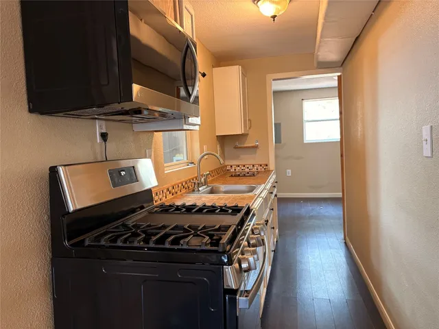 a kitchen with a stove and a microwave