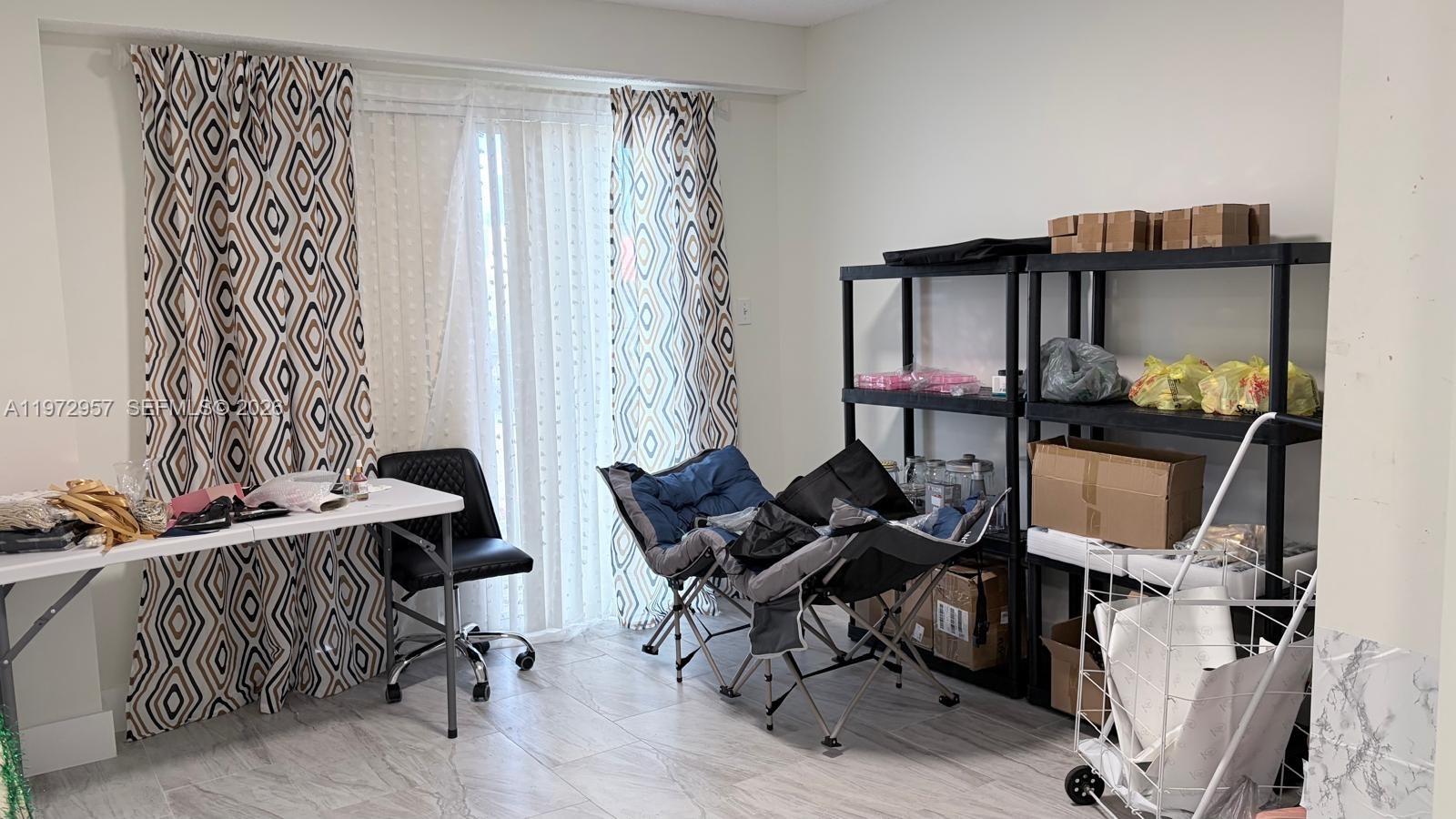 199 Southwest 12th Avenue, Unit 415B Miami, FL 33130 - Photo 25 of 39 a living room with furniture and a window