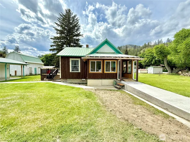 a front view of a house with a yard table and chairs
