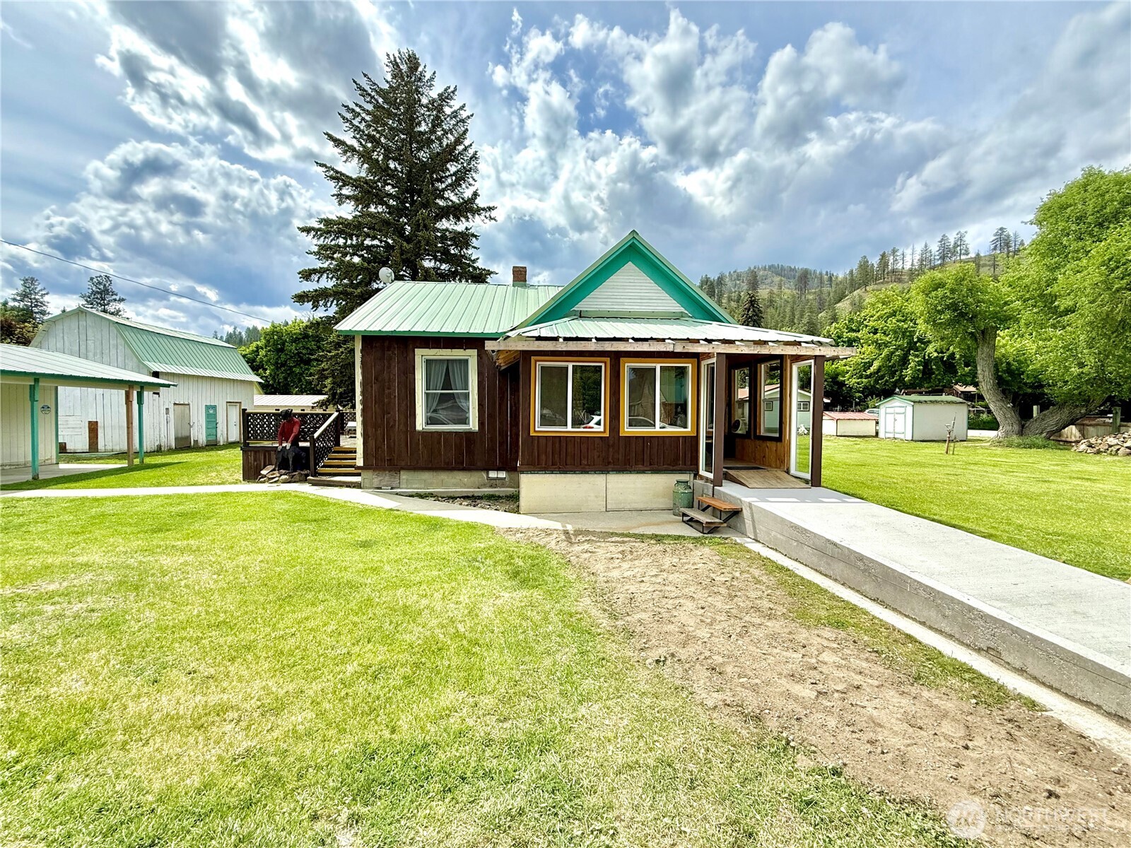 a front view of a house with a yard table and chairs