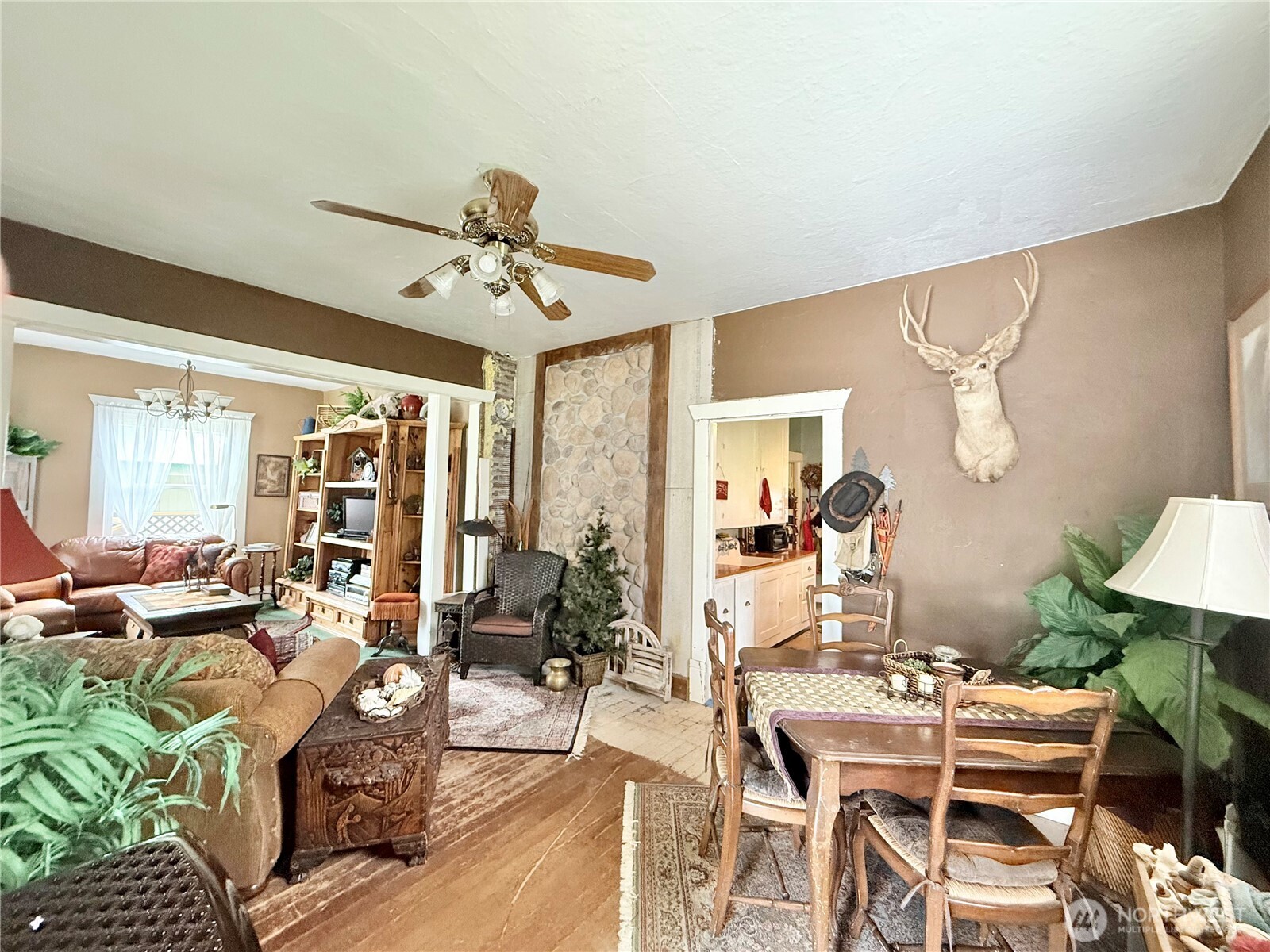 119 North Main Street Conconully, WA 98819 - Photo 14 of 30 a living room with furniture a chandelier and a dining table
