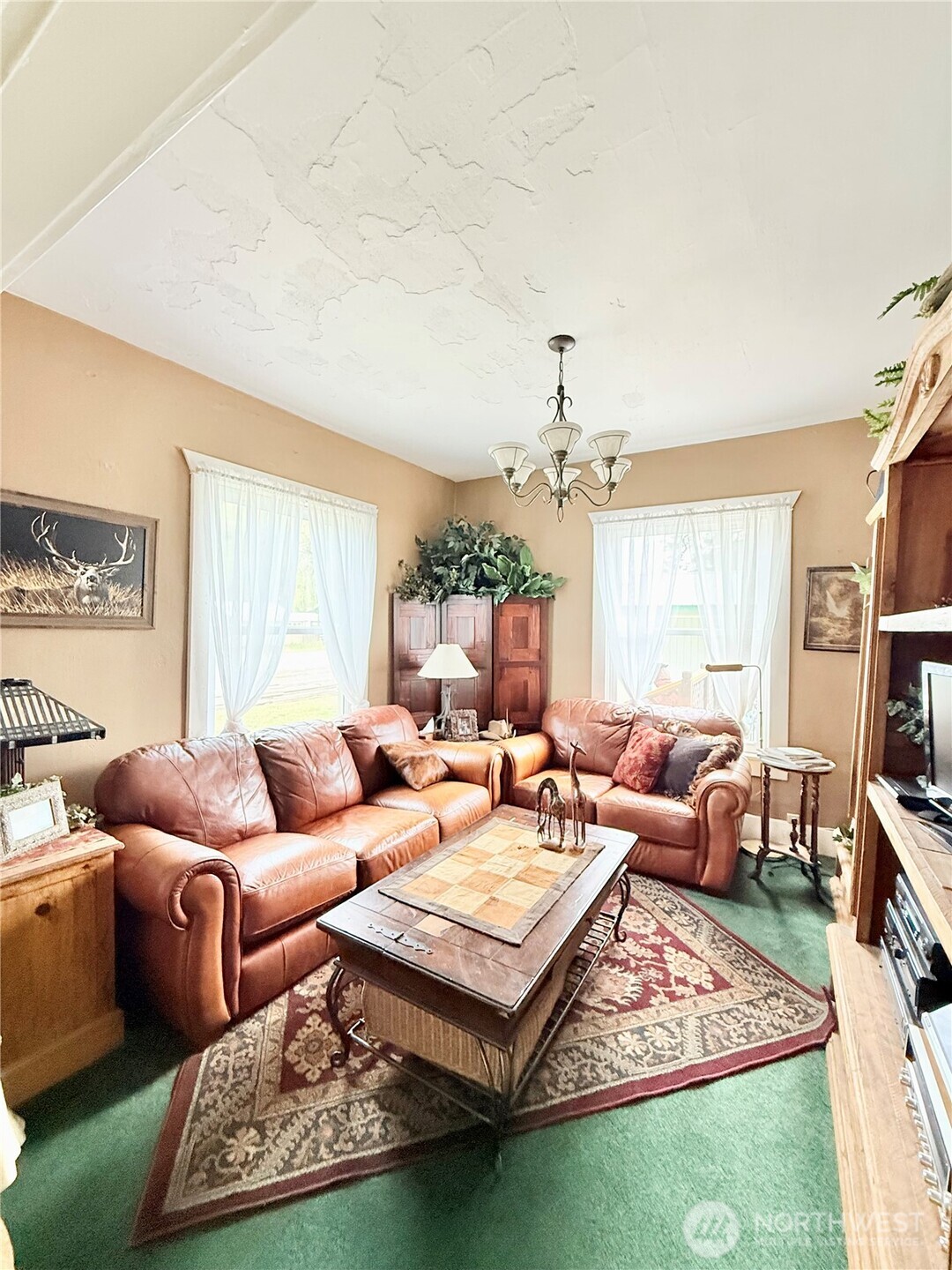 119 North Main Street Conconully, WA 98819 - Photo 17 of 30 a living room with furniture a rug and a chandelier