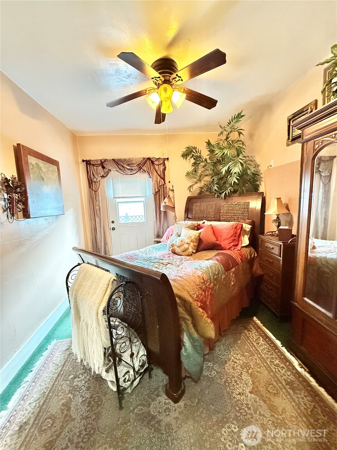 119 North Main Street Conconully, WA 98819 - Photo 24 of 30 a bedroom with a bed and a chandelier