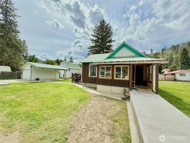 a front view of a house with a garden