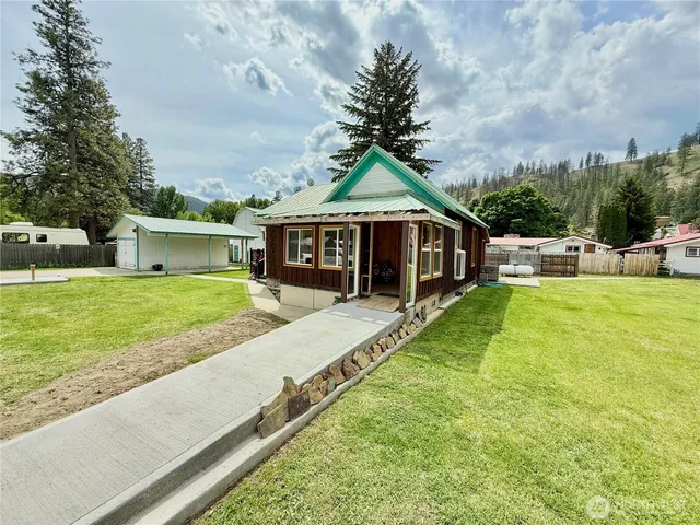 a view of house with swimming pool and view of a house