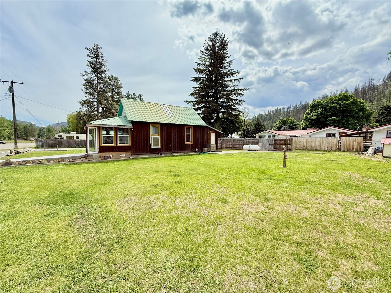 119 North Main Street Conconully, WA 98819 - Photo 6 of 30 a view of a house with a big yard