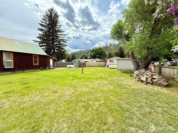 a view of a house with a yard and sitting area