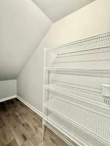 a view of a room with wooden floor