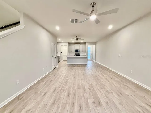 a view of a kitchen with a sink and wooden floor