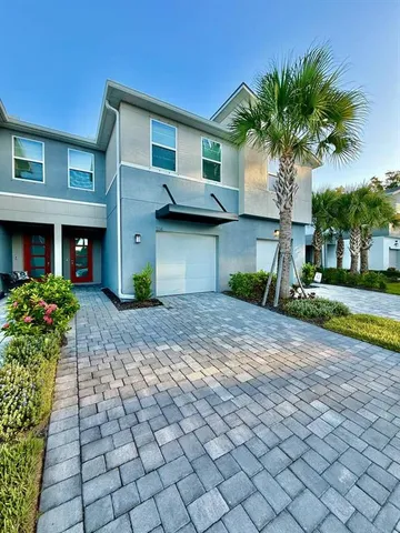 a front view of a house with a yard and a garage