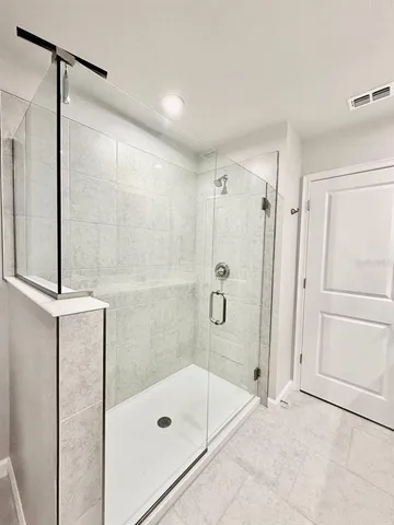 an empty room with a ceiling fan and window