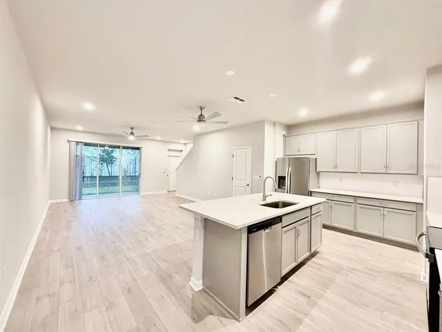 a kitchen with a sink stove and cabinets