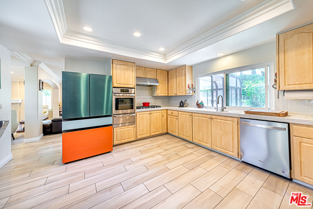 1195 Vía Pintada Riverside, CA 92507 - Photo 12 of 51 a kitchen with stainless steel appliances granite countertop a stove sink and cabinets