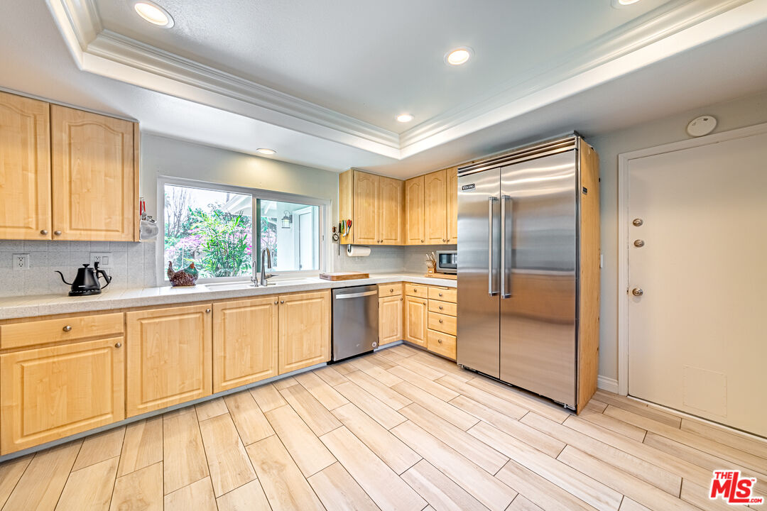1195 Vía Pintada Riverside, CA 92507 - Photo 14 of 51 a large kitchen with a sink stainless steel appliances and cabinets