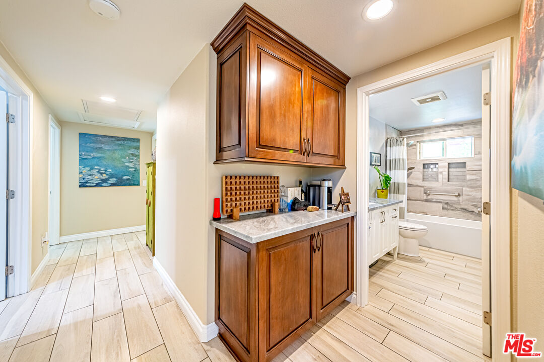 1195 Vía Pintada Riverside, CA 92507 - Photo 17 of 51 a kitchen with granite countertop a stove and a wooden floors