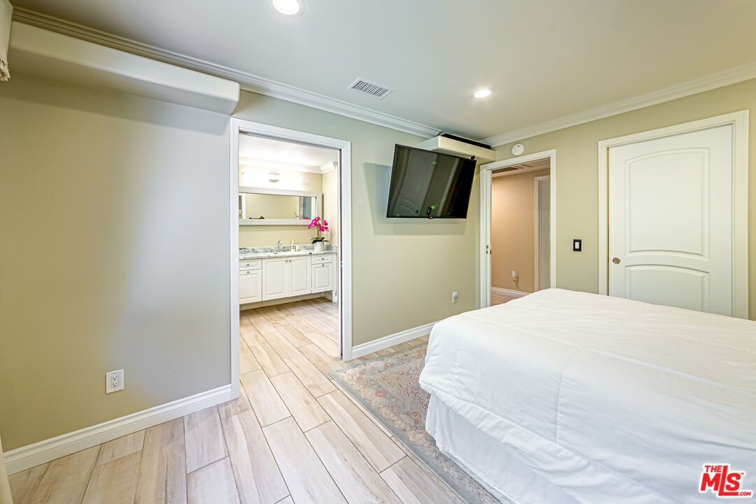 1195 Vía Pintada Riverside, CA 92507 - Photo 21 of 51 a bedroom with a bed and a flat screen tv